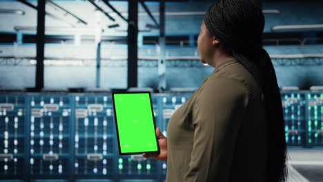 admin with isolated screen tablet in data center doing power management