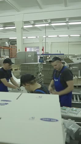 workers in warehouse preparing goods for dispatch