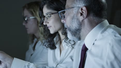 coworkers discussing work in dark office