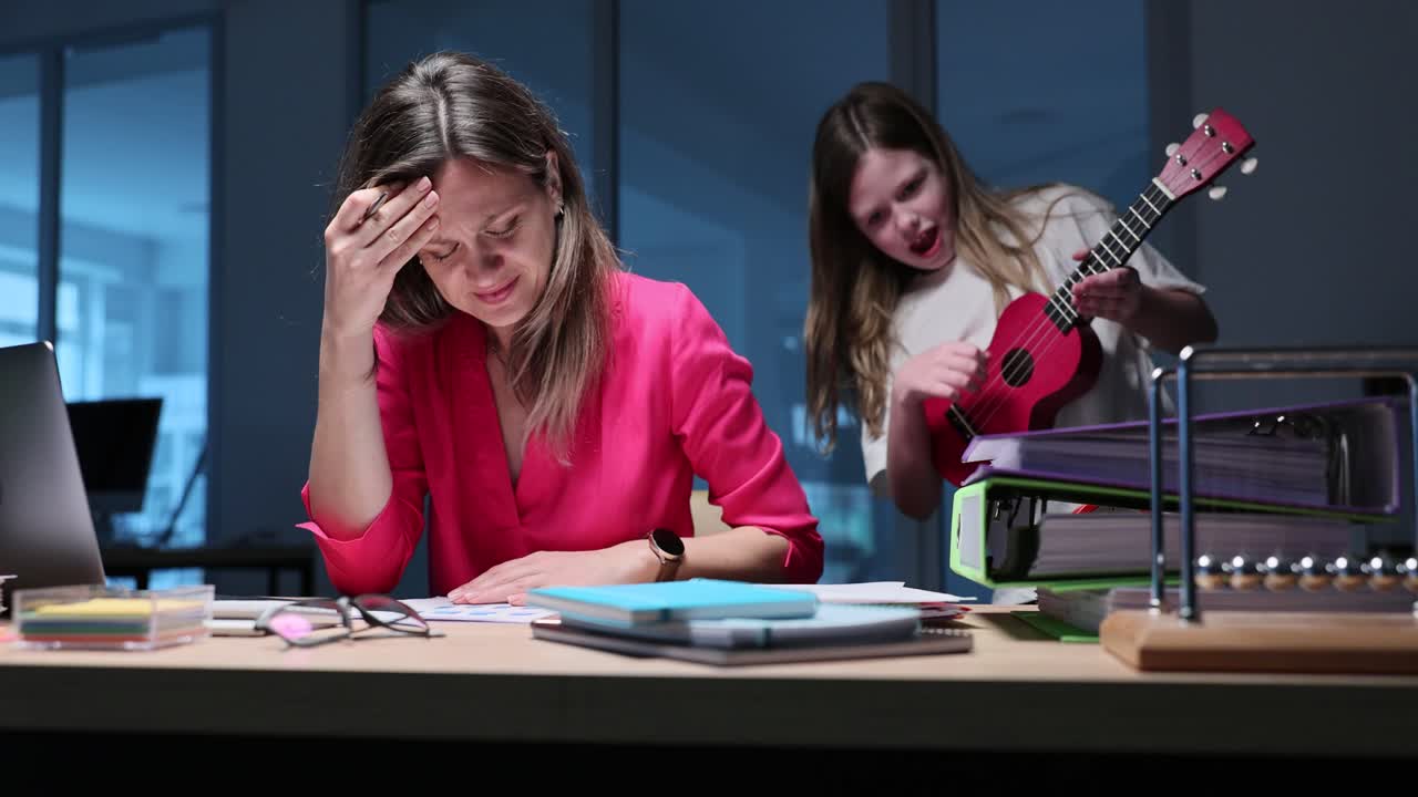 Donna stressata che lavora da casa mentre la figlia suona l'ukulele