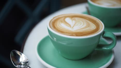 two cups of latte art coffee