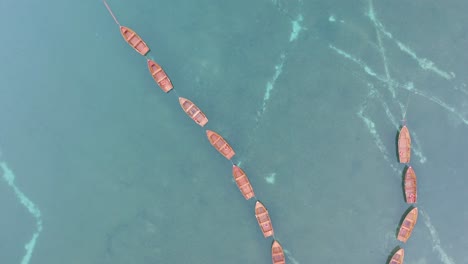 Top-Down-View-of-Wooden-Boats-on-Lago-di-Braies-in-Italy