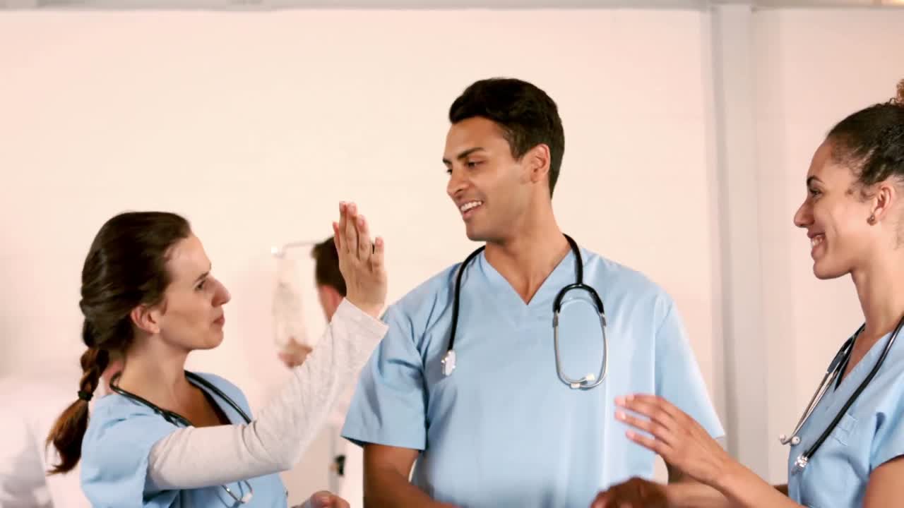 Happy medical team doing high five