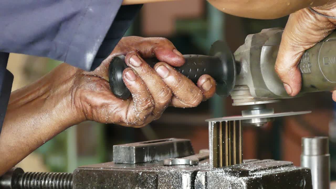 Closeup man grinding piece of metal