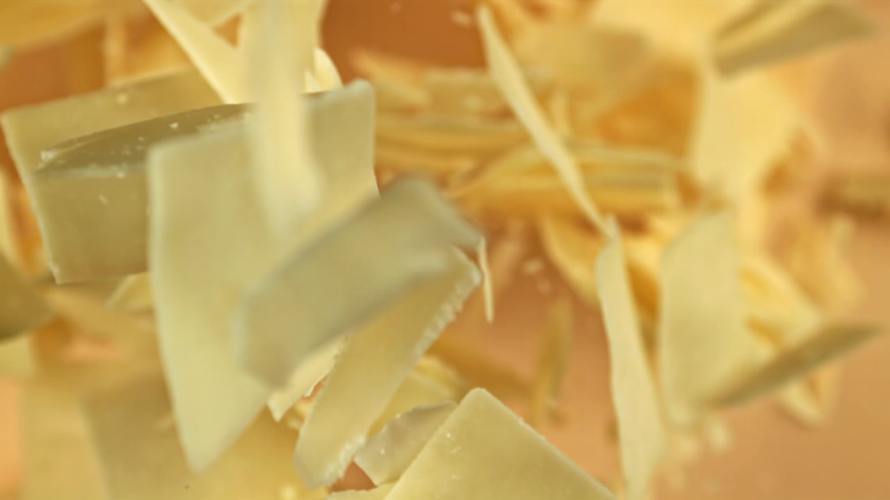 Parmesan Cheese Flakes Falling in Slow Motion