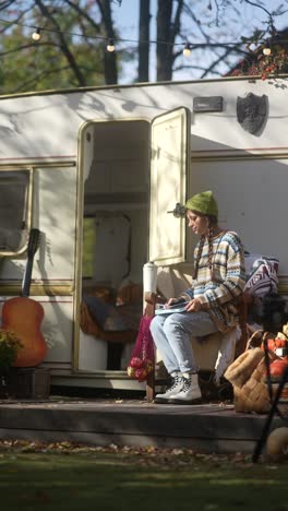 woman relaxing in a campervan on a sunny autumn day