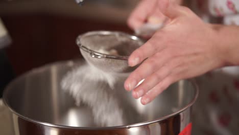 sifting flour into a mixing bowl