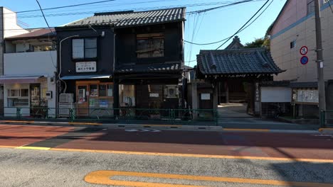 different cars driving down a quaint town road