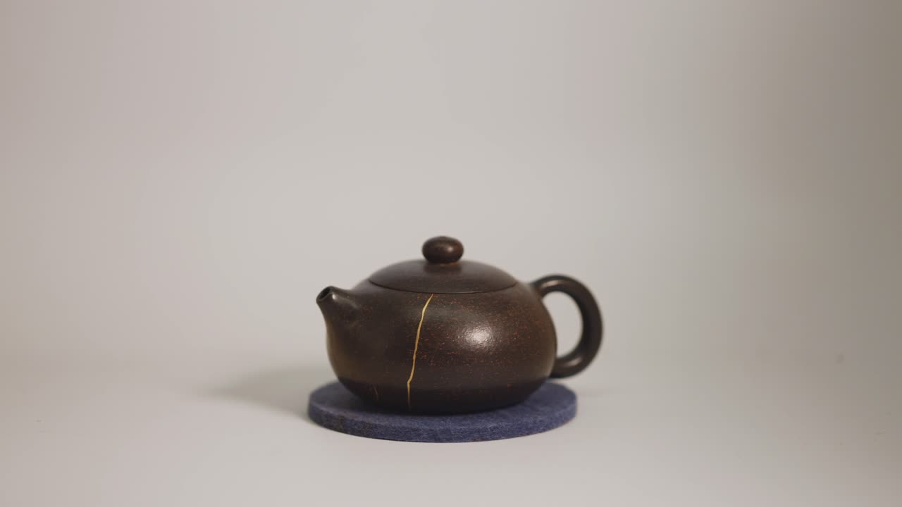 Small Brown Teapot with Golden Crack Repair