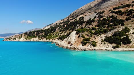 lush cliffs and blue ocean at agia kiriaki beach in kefalonia, greece - aerial drone shot