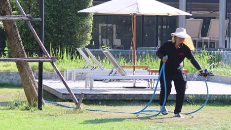 worker installs and tests a lawn sprinkler