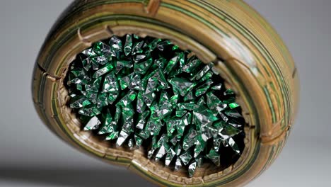 green crystal cluster in carved wooden bowl