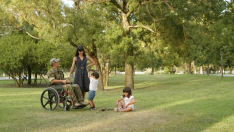 active sibling children enjoying time with handicapped dad