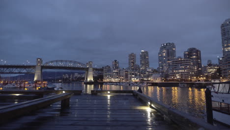 Wet-boardwalk-on-Granville-Island-and-Burrard-bridge-at-night