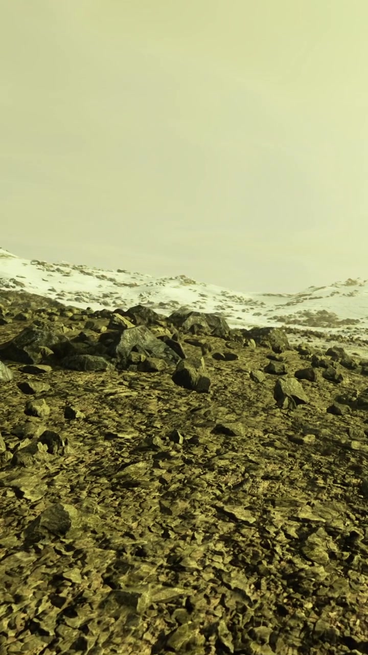 Rocky landscape with snow in a distant mountain area during daylight hours