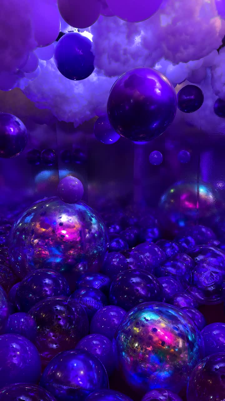 Shiny purple balloons and cotton clouds, futuristic party decor