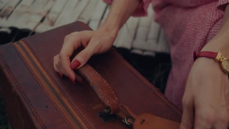 woman preparing for a trip with vintage suitcase