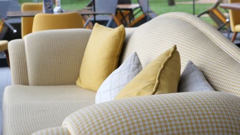 yellow sofa with pillows in a cafe setting