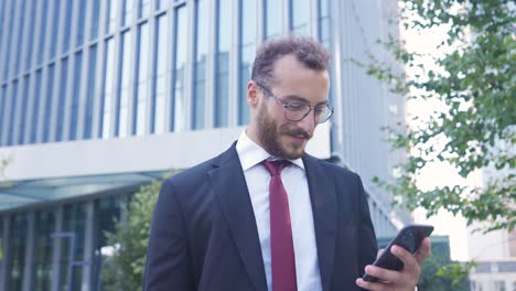 Happy-businessman-using-phone.