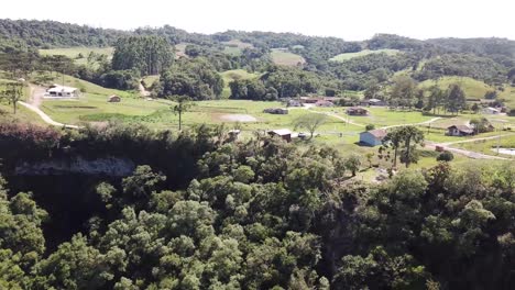 drone footage of a beautiful landscape near a canyon and a waterfall.