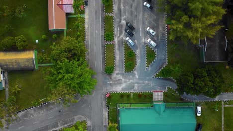 Cinematic-Drone-Footage-of-Palm-Oil-Mill-Effluent-residential-consists-of-buildings,-homes,-main-road-and-infrastructure-surrounded-by-palm-oil-trees-deforestation-located-in-Indonesia-in-full-HD