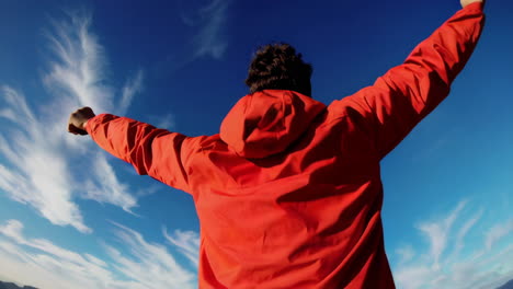 man on mountain top enjoying the view