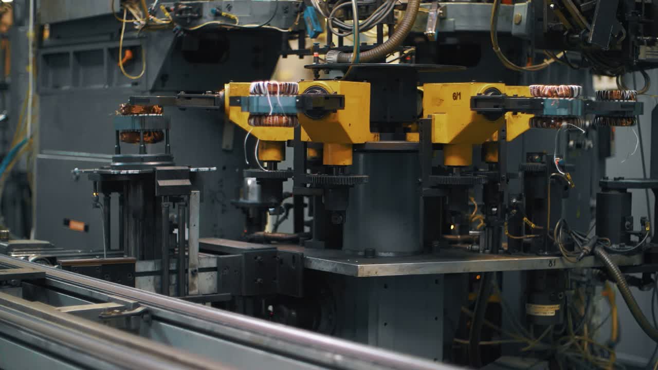 Metal detail with copper wire moving on assembly line at industrial factory