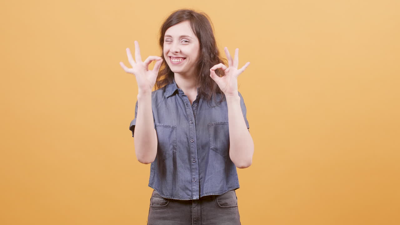Woman making okay gesture