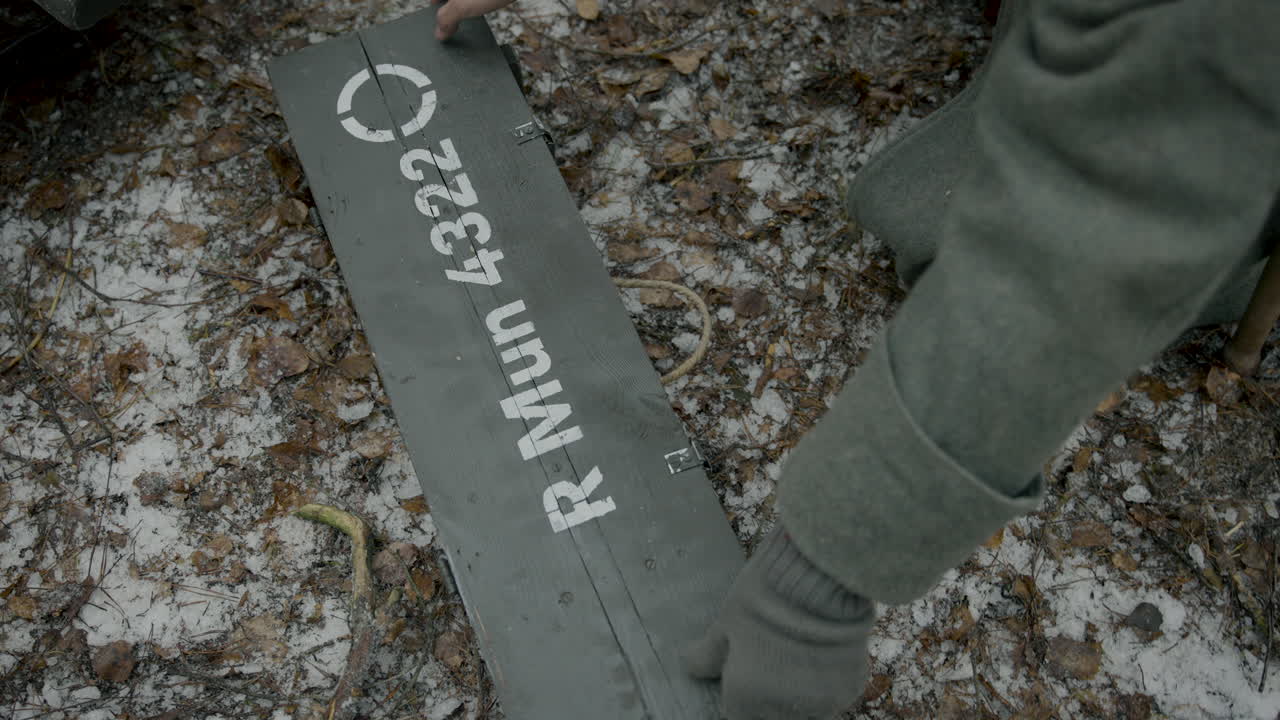 Opening a Wooden Box of Grenades in a Snowy Forest
