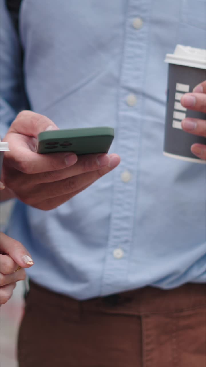 Close up of people with coffee and using a phone