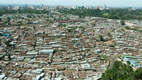 aerial trucking shot over large slum of nairobi during sunny day