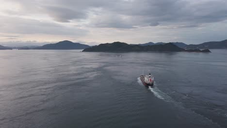 cargo ship in inland sea of japan, slow motion pan over shikoku