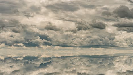 futuristic background consisting of time lapse clip of white fluffy clouds over blue sky and their reflection, video loop