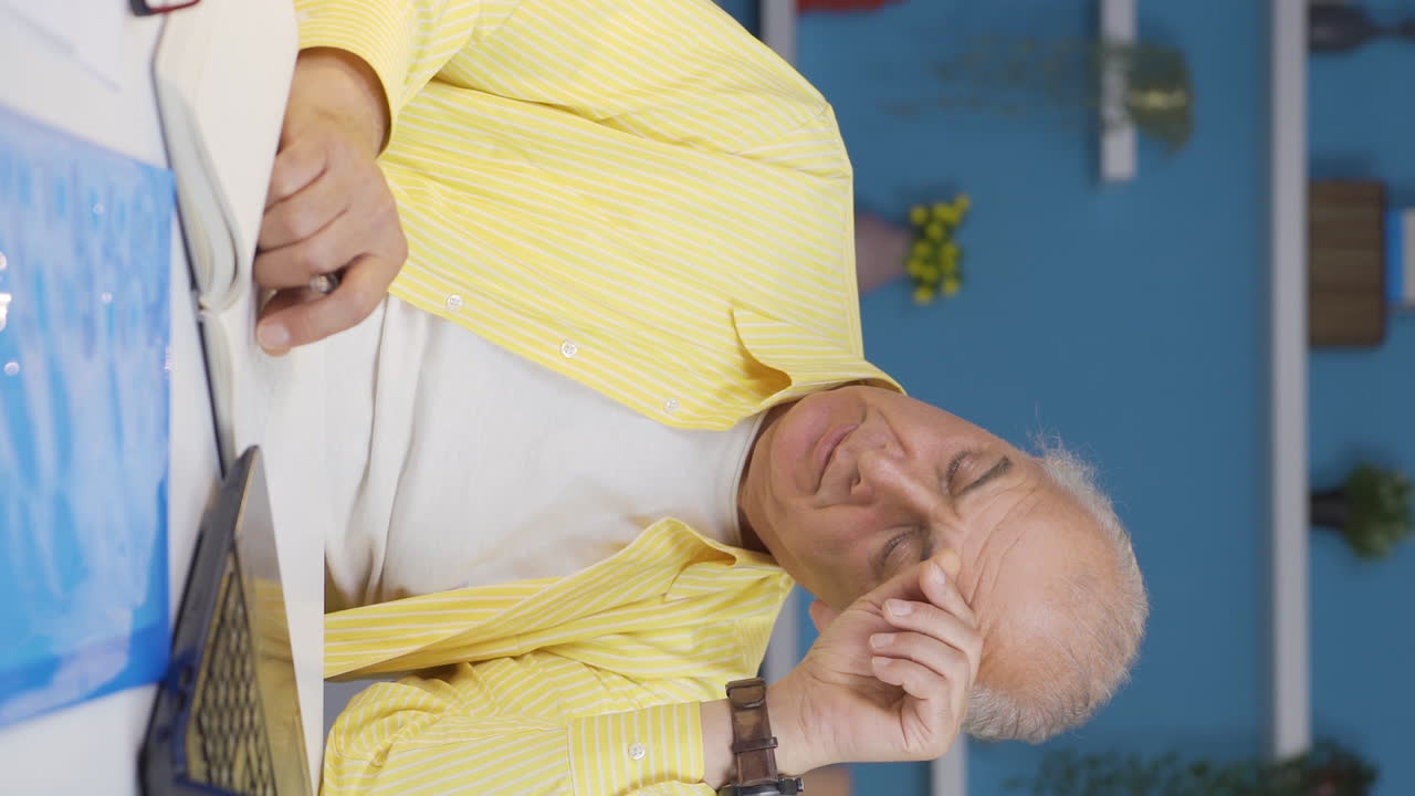 홈 오피스 직원의 수직 비디오 노인이 우울하고 불행합니다.