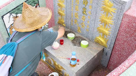 person performing a ritual with food offerings