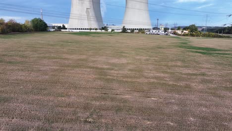 aerial reveal of nuclear power plant dukovany cooling towers and powerline