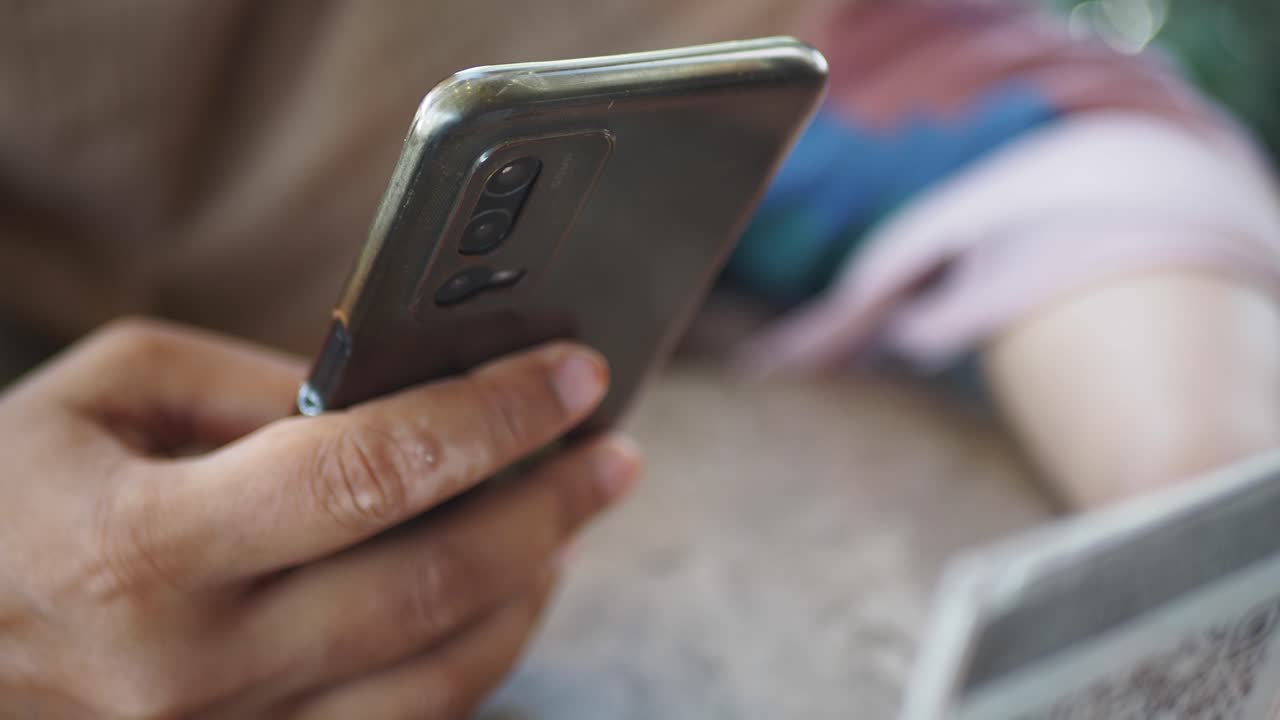 Close-up of a person holding and using a smartphone