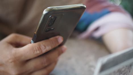 close-up of a person holding and using a smartphone