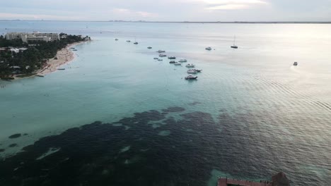 Isla-mujeres-Mexico-Cancun-riviera-maya-aerial-view-of-coral-reef-tropical-Caribbean-Sea-ocean-white-sand-tropical-beach-resort-town-drone-footage