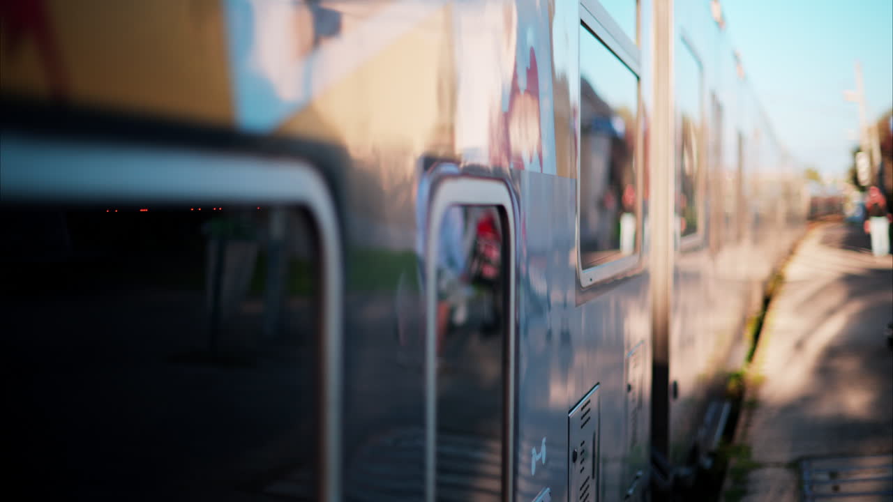 Close up of a blue train stopping at the station in France, with people waiting to enter it