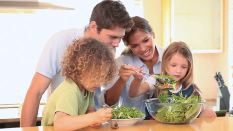 family mixing lettuce