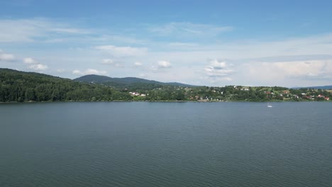 Landscape-of-majestic-Zywiec-lake-in-Beskid-mountains-during-a-summer-day---aerial-view-4K