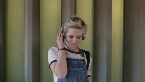 portrait of young woman wearing headphones listening to music alternative grunge