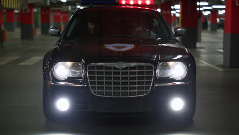 police car exploring territory at night. police officers driving patrol vehicle