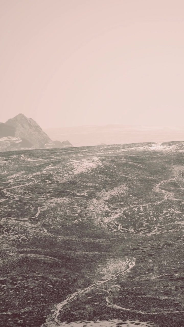 Waves crash on a rocky shore during a foggy early morning