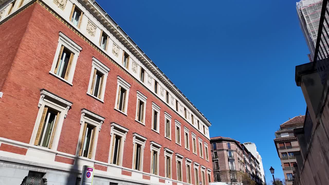 Shot of contemplation of the building facades on Calle de la Academia in downtown Madrid