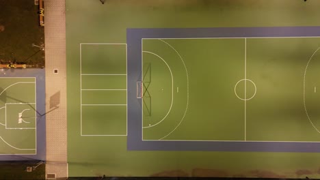 aerial view from drone to soccer and basketball field at night