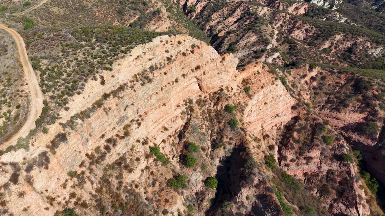 Aerial view of steep canyon slopes and a rugged trail cutting through Black Star Canyon Wilderness