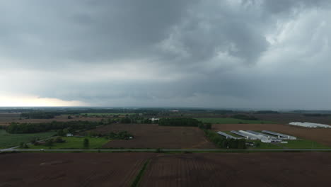 Aerial-forwarding-shot-of-farms-on-a-cloudy-moody-day-in-Canada