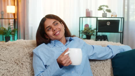 indian woman drinking tea with peaceful face at home enjoying calm personal moment of relaxation